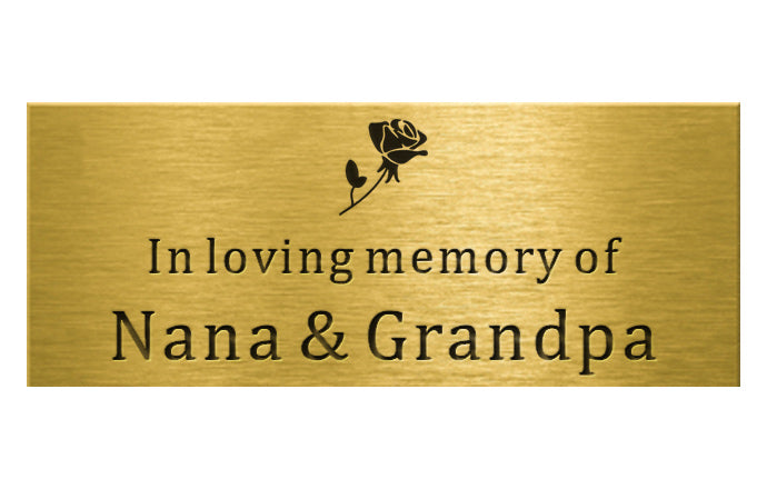 brass plaque with 'In loving memory of Nana & Grandpa' text and rose design on a white background