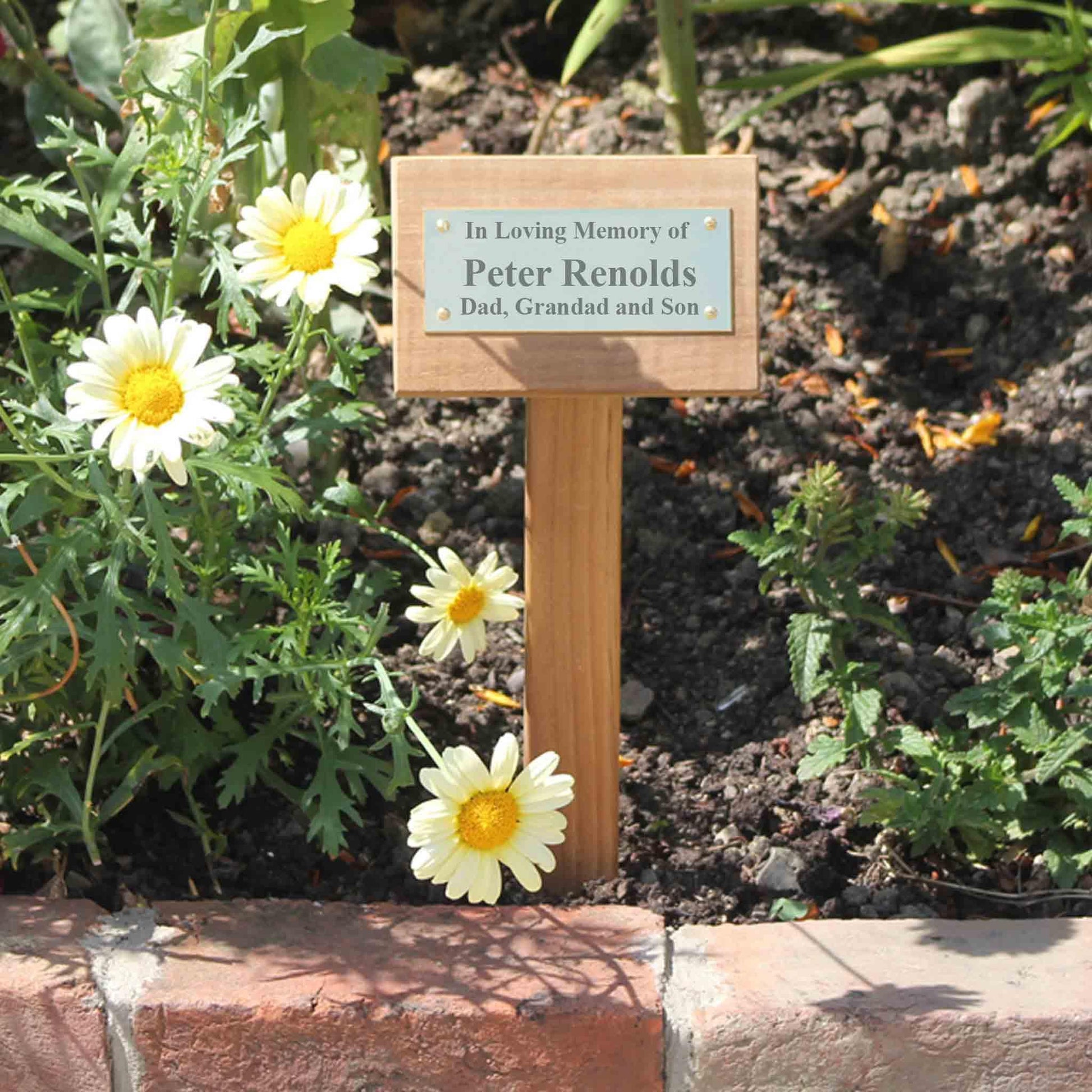 grave marker displayed in a flower bed