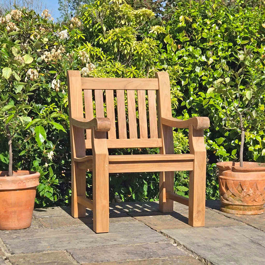 memorial armchair on a patio with greenery in the background