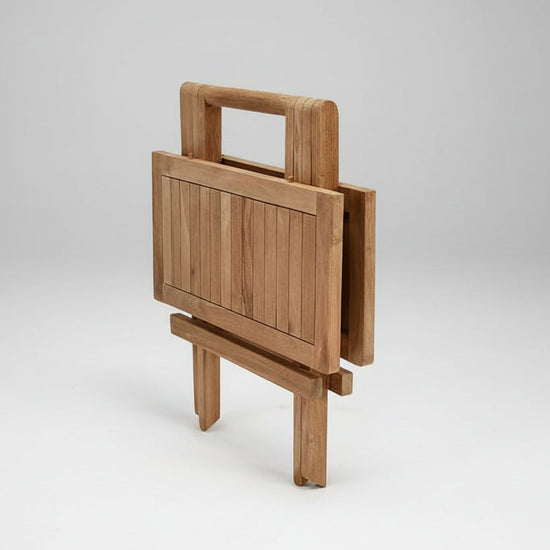 Wooden square folding coffee 
table on a white background