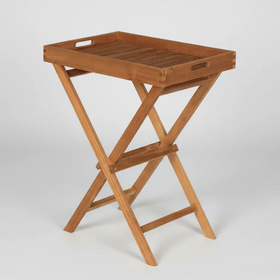 Wooden teak folding tray table and stand on a white background