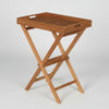 Wooden teak folding tray table and stand on a white background