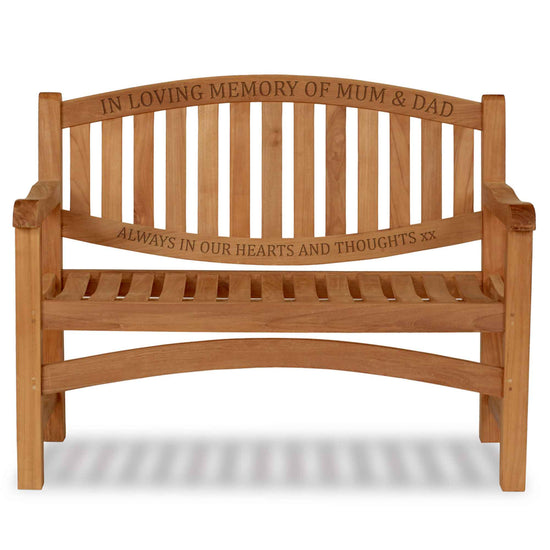Wooden memorial bench with engraved text in loving memory of Mum & Dad on a white background