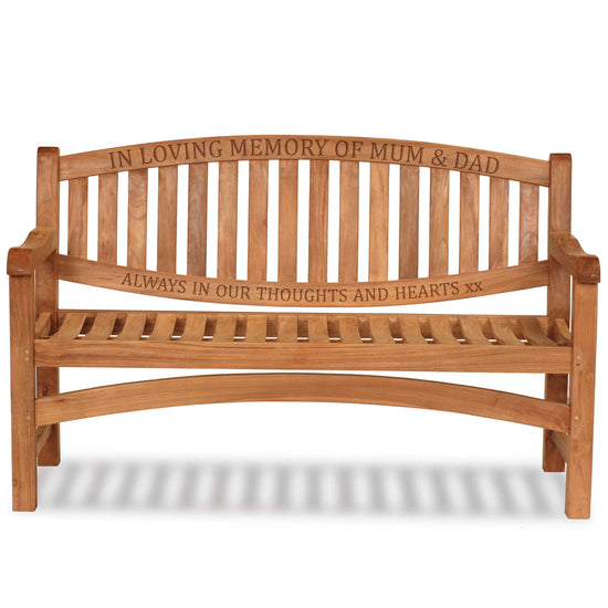 Wooden commemorative bench with engraved text on two rails on a white background