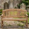 Wooden memorial bench with engraved text in a cemetery