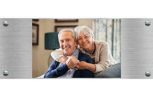 photo memorial plaque with elderly couple sitting together on a couch.
