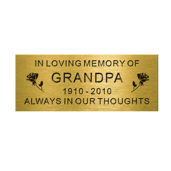 Brass plaque with engraved text 'In Loving Memory of Grandpa 1910-2010 Always in Our Thoughts' on a white background