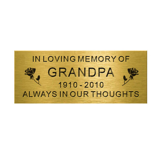 Brass plaque with engraved text 'In Loving Memory of Grandpa 1910-2010 Always in Our Thoughts' on a white background