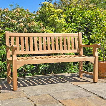 remembrance bench in a garden setting on a patio