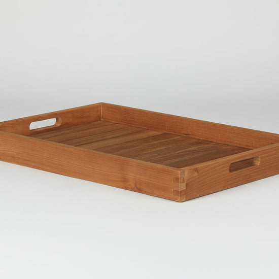 Wooden butlers tray with handles on a white background