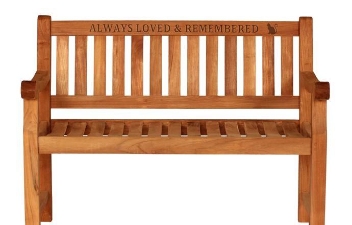 carved words on a wooden memorial bench